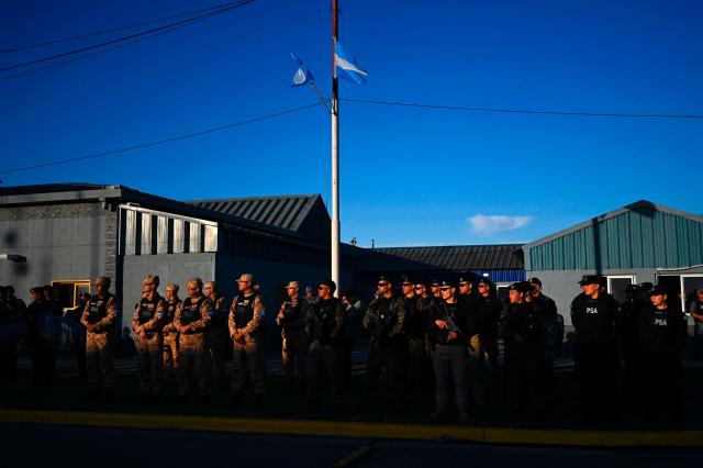 Members of Argentina's security forces listen to President Javier Milei's speech during the official presentation of a comprehensive reform bill for the Penal Code at Federal Penitentiary Complex No. 1 in Ezeiza, Buenos Aires province, on October 2, 2025. (Photo by Luis ROBAYO / AFP)