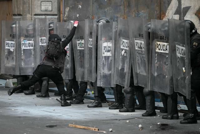 A demonstrator clashes with riot police during a rally commemorating the 57th anniversary of the 1968 Tlatelolco student massacre in Mexico City on October 2, 2025. (Photo by Yuri CORTEZ / AFP)
