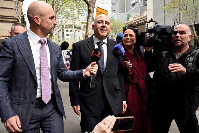 Melbourne gangland personality Tony Mokbel (C) arrives at the Victorian Court of Appeal in Melbourne on October 3, 2025. Mokbel is fighting to overturn drug trafficking convictions that saw him jailed for three decades with his legal team argueing he suffered a miscarriage of justice because of the actions of Nicola Gobbo, his former barrister who was a secret police informer. (Photo by William WEST / AFP)