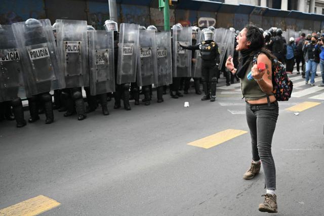 A demonstrator shouts slogans to riot police officers during a rally commemorating the 57th anniversary of the 1968 Tlatelolco student massacre in Mexico City on October 2, 2025. (Photo by Yuri CORTEZ / AFP)