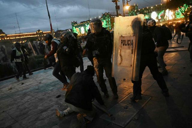 Riot police clash with demonstrators during a rally commemorating the 57th anniversary of the 1968 Tlatelolco student massacre in Mexico City on October 2, 2025. (Photo by Yuri CORTEZ / AFP)