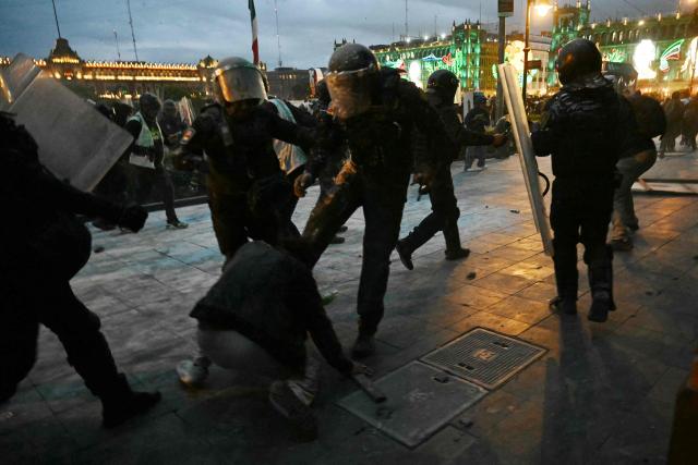 Riot police clash with demonstrators during a rally commemorating the 57th anniversary of the 1968 Tlatelolco student massacre in Mexico City on October 2, 2025. (Photo by Yuri CORTEZ / AFP)
