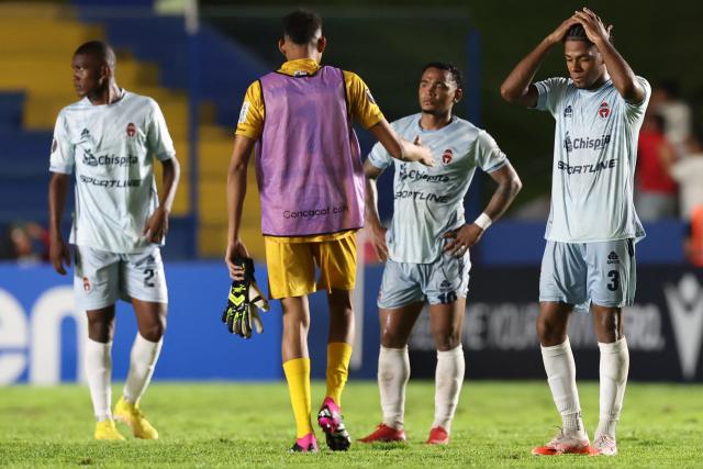 Sporting San Miguelito's defender #02 Jael Garibaldi, goalkeeper #01 Kevin Mosquera, midfielder #10 Yair Jaen and  defender #03 Kadir Hurtado react after losing the CONCACAF Central American Cup quarter-final second leg football match between Panama's Sporting San Miguelito and Guatemala's Xelaju at the Estadio Universitario in Penonome, Panama on October 2, 2025. (Photo by MARTIN BERNETTI / AFP)