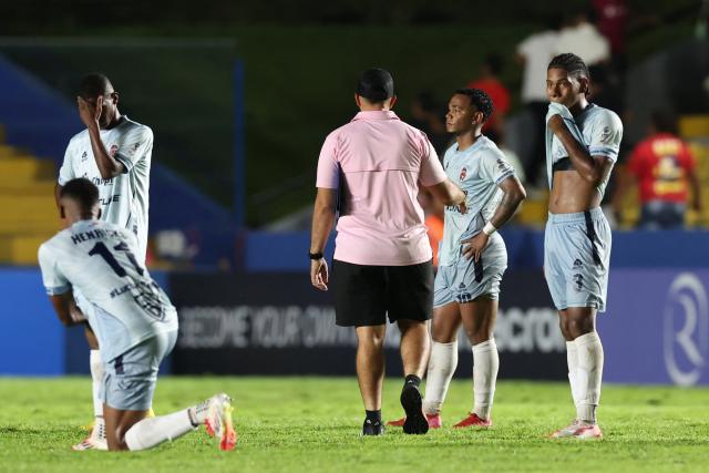 Sporting San Miguelito's forward #11 Adan Henricks, defender #02 Jael Garibaldi, midfielder #10 Yair Jaen and defender #03 Kadir Hurtado react after losing the CONCACAF Central American Cup quarter-final second leg football match between Panama's Sporting San Miguelito and Guatemala's Xelaju at the Estadio Universitario in Penonome, Panama on October 2, 2025. (Photo by MARTIN BERNETTI / AFP)