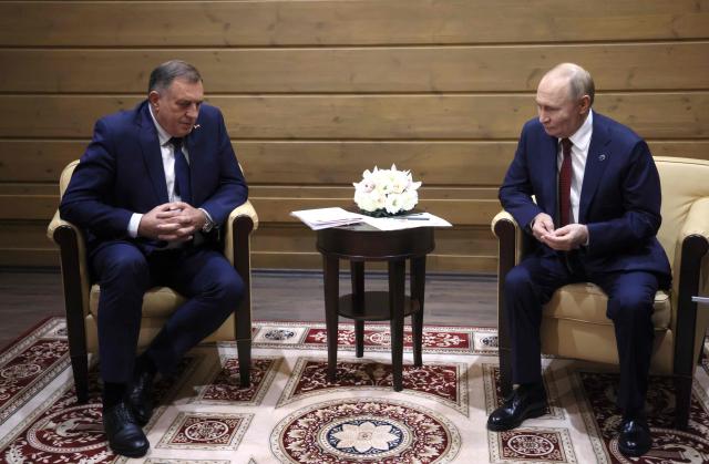 In this pool photograph distributed by the Russian state agency Sputnik, Russia's President Vladimir Putin meets with Bosnian Serb leader Milorad Dodik in Sochi on October 2, 2025. (Photo by Mikhail METZEL / POOL / AFP)