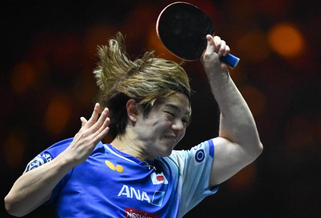 Japan's Yukiya Uda hits a return to China's Lin Shidong during their men’s singles quarterfinal match at the China Smash table tennis tournament in Beijing on October 3, 2025. (Photo by ADEK BERRY / AFP)