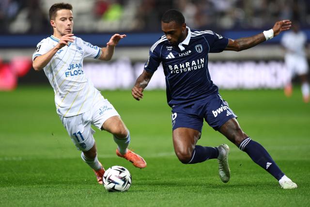 Lorient's French midfielder #11 Theo Le Bris (L) fights for the ball with Paris FC's Brazilian defender #06 Otavio during the French L1 football match between Paris FC and FC Lorient at the Stade Jean-Bouin in Paris on October 3, 2025. (Photo by FRANCK FIFE / AFP)