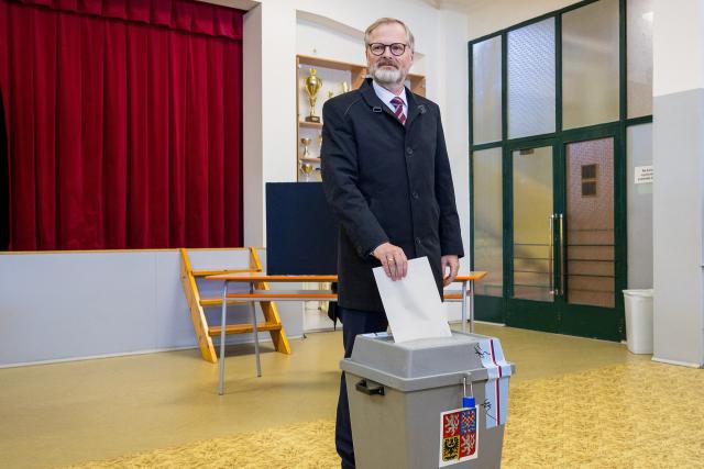 TOPSHOT - Czech Prime Minister Petr Fiala casts his ballot in the parliamentary elections at a polling station in Brno, South Moravia, Czech Republic, on October 3, 2025. Polling stations across the Czech Republic opened on October 3 for a two-day general election. (Photo by Radek Mica / AFP)