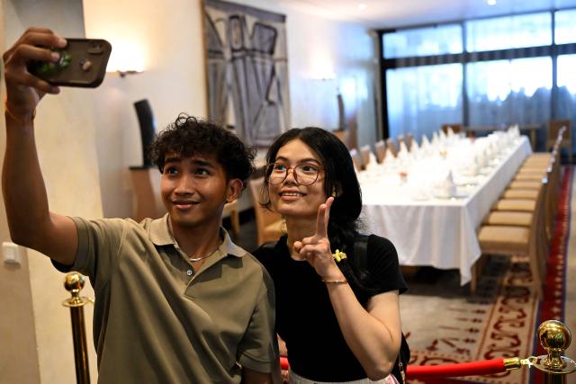 A couple takes a selfie at the French Embassy which opened its doors to the public for its annual French Embassy Heritage Day in Phnom Penh on October 4, 2025. (Photo by TANG CHHIN Sothy / AFP)