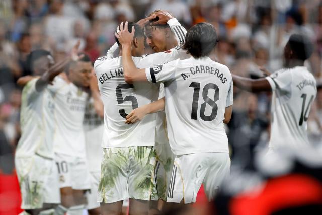 Real Madrid's players celebrate their third goal scored by French forward #10 Kylian Mbappe (2L) during the Spanish league football match between Real Madrid CF and Villarreal CF at the Santiago Bernabeu stadium in Madrid on October 4, 2025. (Photo by Oscar DEL POZO / AFP)