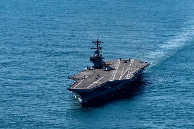 The USS George H.W. Bush aircraft carrier sails in the Atlantic Ocean off the coast of Norfolk, Virginia on October 4, 2025. (Photo by Alex Brandon / POOL / AFP)