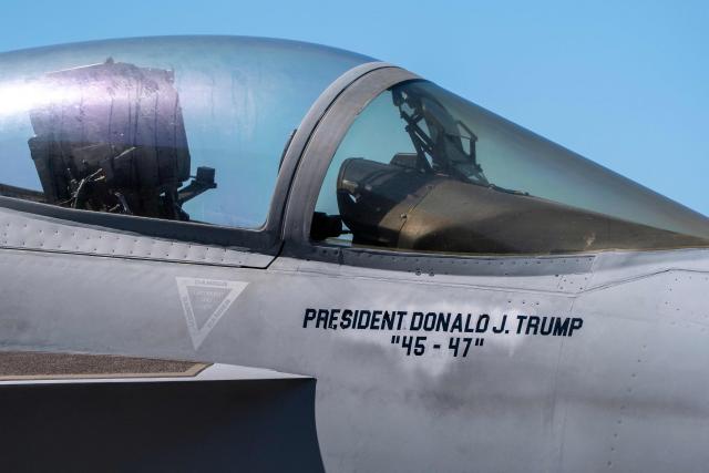 An F/A-18E fighter jet with President Donald Trump’s name stenciled onto is seen aboard the USS George H.W. Bush aircraft carrier in the Atlantic Ocean off the coast of Norfolk, Virginia on October 4, 2025. (Photo by Alex Brandon / POOL / AFP)
