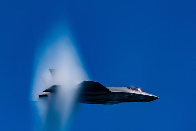 An F-35C fighter jet does a high speed pass as seen from the USS George H.W. Bush aircraft carrier in the Atlantic Ocean off the coast of Norfolk, Virginia on October 4, 2025. (Photo by Alex Brandon / POOL / AFP)