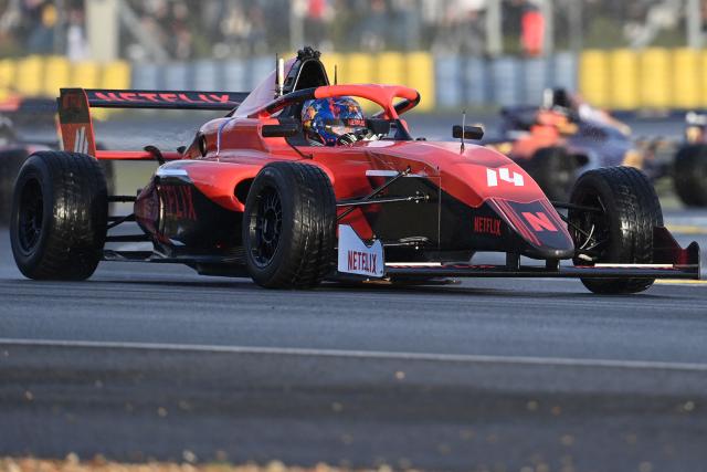 French YouTuber Lucas Hauchard, aka "Squeezie", competes in a sprint race, part of the F4 GP Explorer racing event at the Bugatti circuit in Le Mans, western France, on October 4, 2025. The three-day event brought together 200,000 spectators and some of the biggest names in French rap. (Photo by JEAN-FRANCOIS MONIER / AFP)