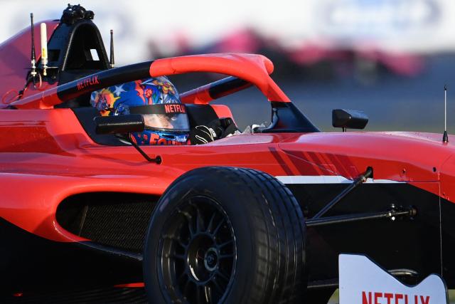 French YouTuber Lucas Hauchard, aka "Squeezie", competes in a sprint race, part of the F4 GP Explorer racing event at the Bugatti circuit in Le Mans, western France, on October 4, 2025. The three-day event brought together 200,000 spectators and some of the biggest names in French rap. (Photo by JEAN-FRANCOIS MONIER / AFP)