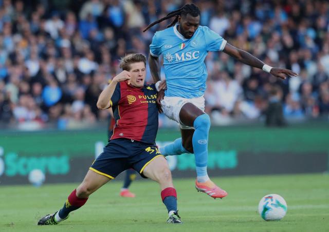 Genoa's Danish midfielder #32 Morten Frendrup (L) and Napoli's Cameroonian midfielder #99 Andre-Frank Anguissa (R) fight for the ball during the Italian Serie A football match football match between SSC Napoli and Genoa CFC at the Diego Armando Maradona stadium in Naples on October 5, 2025. (Photo by CARLO HERMANN / AFP)