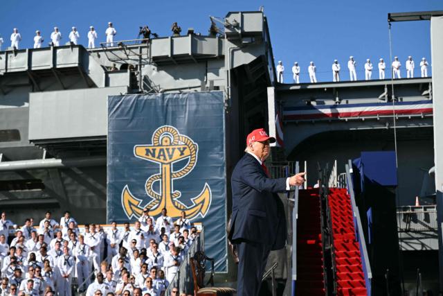 US President Donald Trump gestures during a visit to the USS Harry S. Truman during the US Navy's 250th anniversary celebration, "America's Navy 250: Titans of the Sea - A Salute to the Fleet", at Naval Station Norfolk Pier 14 in Norfolk, Virginia on October 5, 2025. (Photo by SAUL LOEB / AFP)