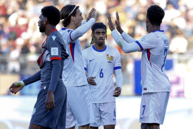 France's midfielder #17 Andrea Le Borgne (2nd-L) celebrates with teammates after scoring his team's sixth goal during the 2025 FIFA U-20 World Cup football match between New Caledonia and France, at the Fiscal stadium in Talca, Chile, on October 5, 2025. (Photo by Raul BRAVO / AFP)