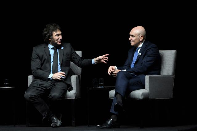 (FILES) Argentine President Javier Milei (L) speaks next to National Deputy Jose Luis Espert during the presentation of his new book "Capitalism, Socialism, and the Neoclassical Trap" at the Luna Park stadium in Buenos Aires on May 22, 2024. Jose Luis Espert, a deputy member of Argentine President Javier Milei's party, withdrew his candidacy for the end-of-month legislative elections on October 5, 2025, after acknowledging payments from a businessman who is under investigation for drug trafficking, a case that Milei attributed to a "sinister operation" by the opposition. (Photo by LUIS ROBAYO / AFP)