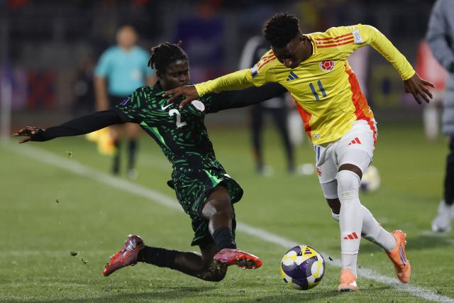 Nigeria's defender #2 Amos Ochoche and Colombia's forward #11 Jhon Renteria fight for the ball during the 2025 FIFA U-20 World Cup football match between Nigeria and Colombia, at the Fiscal stadium in Talca, Chile, on October 5, 2025. (Photo by Raul BRAVO / AFP)