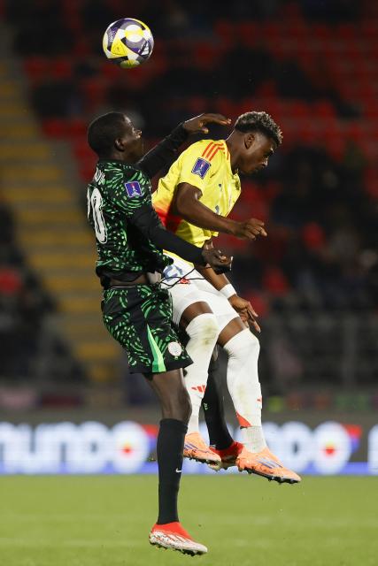 Nigeria's defender #20 Haruna Aliyu and Colombia's forward #21 Neiser Villarreal fight for the ball during the 2025 FIFA U-20 World Cup football match between Nigeria and Colombia, at the Fiscal stadium in Talca, Chile, on October 5, 2025. (Photo by Raul BRAVO / AFP)