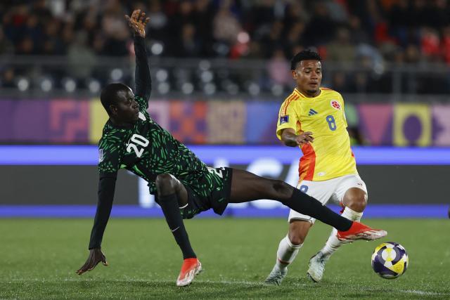 Nigeria's defender #20 Haruna Aliyu and Colombia's midfielder #08 Royner Benitez fight for the ball during the 2025 FIFA U-20 World Cup football match between Nigeria and Colombia, at the Fiscal stadium in Talca, Chile, on October 5, 2025. (Photo by Raul BRAVO / AFP)