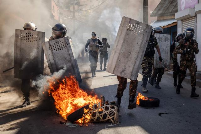 TOPSHOT - Malagasy police officers run to push back protesters during clashes at a demonstration calling for the resignation of President Andry Rajoelina, in Antananarivo, on October 6, 2025. Hundreds of people demonstrated in Madagascar's capital, Antananarivo, on Monday -- the 12th day of a youth-led protest movement that has plunged the country into political crisis.
Near-daily protests that started on September 25 against persistent water and power cuts in the Indian Ocean island have grown into an anti-government movement calling for President Andry Rajoelina to resign. (Photo by Luis TATO / AFP)