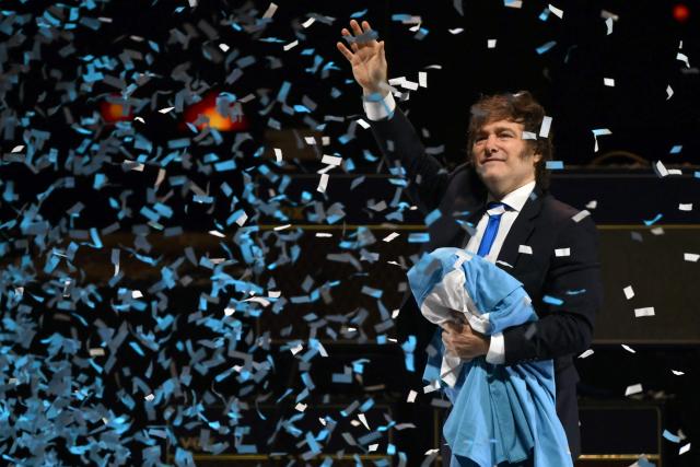 Argentina's President Javier Milei waves to supporters during the launch of his new book, "The Making of the Miracle," at the Movistar Arena in Buenos Aires on October 6, 2025. (Photo by Luis ROBAYO / AFP)