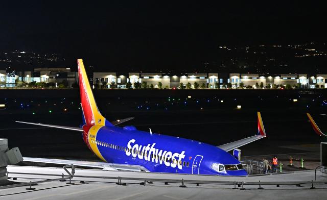 A Southwest Airlines jet is seen on the tarmac at the Hollywood Burbank Airport on October 6, 2025 in Burbank, California. Hollywood Burbank Airport, which connects Los Angeles to the rest of the country, had no air traffic controllers on Monday evening, the state's governor said, as the effects of a US government shutdown rippled across the country. The airport was set to be without qualified staff in the control tower for around six hours, Governor Gavin Newsom said. (Photo by Frederic J. BROWN / AFP)