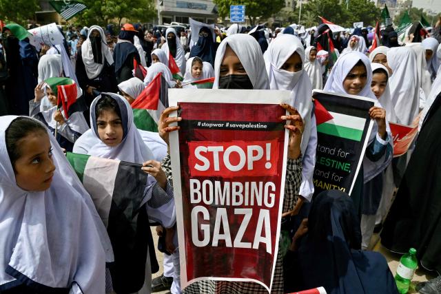 Students carry the Palestinian flag during an anti-Israel protest in Karachi on October 7, 2025, held to mark the second anniversary of the attack that triggered the war between Israel and the militant group Hamas. (Photo by Asif HASSAN / AFP)