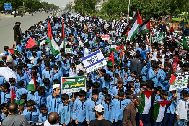 Students carry the Palestinian flag during an anti-Israel protest in Karachi on October 7, 2025, held to mark the second anniversary of the attack that triggered the war between Israel and the militant group Hamas. (Photo by Asif HASSAN / AFP)
