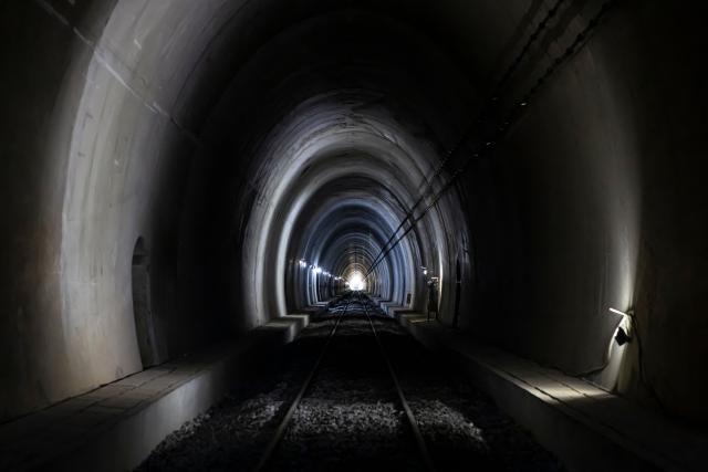 (FILES) A general view of a railway tunnel at the SimFer mining complex in the Simandou mountain range in the Nzerekore region, on September 2, 2025. In the Simandou mountains of Guinea's lush rainforest, a mammoth mining project that could make the west African country one of the world's largest iron exporters is raising equal parts hope and fear.
In just a few weeks, Guinea will export its first shipments of iron ore from its Simandou Project, finally cashing in on the high-grade iron deposits discovered decades ago in the country's southeast.
Not only does the project potentially offer a steady stream of revenue for the impoverished country but it has also precipitated the development of key infrastructure in the region, although the opacity of contracts make it impossible to estimate the state's gains.
Industrial partners have spent approximately $20 billion constructing more than 650 kilometres (400 miles) of railway and a massive port that will connect the remote region to the larger world. (Photo by PATRICK MEINHARDT / AFP)