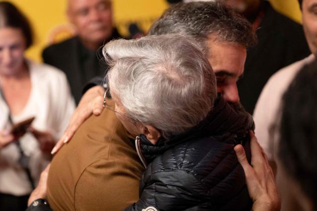 Brazilian actor Wagner Moura (L) embraces musician Caetano Veloso (R) at the gala premiere of the film "O Agente Secreto" (The Secret Agent) during the 27th Rio Film Festival at Cinema Odeon in Rio de Janeiro, Brazil on October 7, 2025. (Photo by Pablo PORCIUNCULA / AFP)