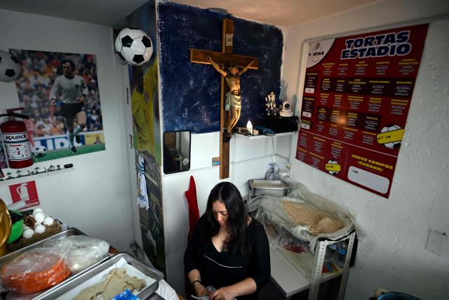 An employee is seen inside of the Mexican restaurant "Tortas Estadio," located in front of the Azteca Stadium in the Santa Ursula neighborhood in Mexico City on October 9, 2025. (Photo by Alfredo ESTRELLA / AFP)