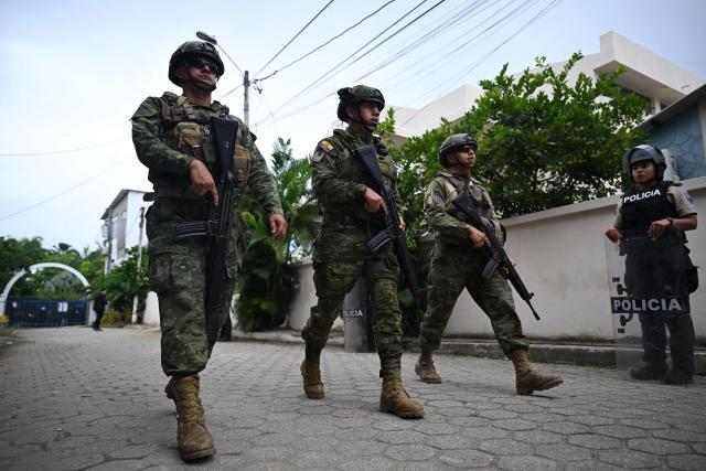 (FILES) Ecuadorean soldiers guard the polling station where Ecuador's President and presidential candidate for the Accion Democratica Nacional party (National Democratic Action), Daniel Noboa is due to vote in Olon, Santa Elena province, Ecuador, on April 13, 2025. Ecuador began deploying up to 3,000 military personnel on October 9, 2025, to maintain order in Quito amid indigenous protests against the government, the army said. (Photo by Raul ARBOLEDA / AFP)