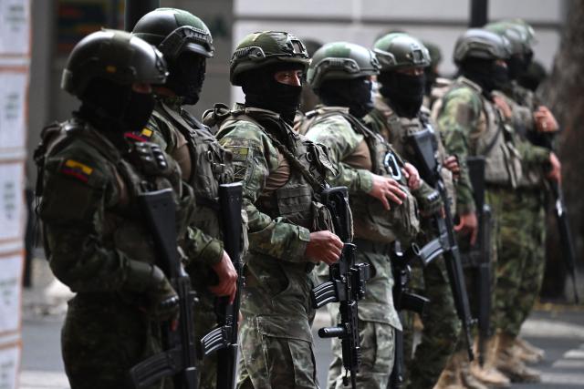 (FILES) Soldiers stand guard before the march for peace and justice in Guayaquil, Ecuador, on September 11, 2025. Ecuador began deploying up to 3,000 military personnel on October 9, 2025, to maintain order in Quito amid indigenous protests against the government, the army said. (Photo by MARCOS PIN / AFP)