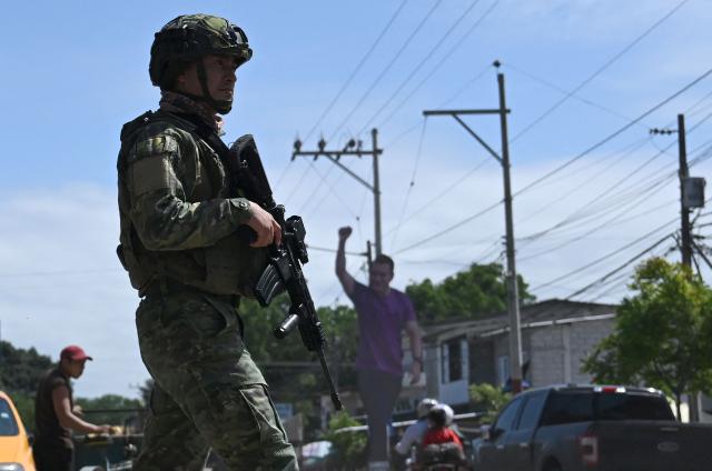 (FILES) An Ecuadorian soldier patrols the street in Olon, Santa Elena province, Ecuador, on April 14, 2025, the day after the presidential runoff election. Ecuador began deploying up to 3,000 military personnel on October 9, 2025, to maintain order in Quito amid indigenous protests against the government, the army said. (Photo by Raul ARBOLEDA / AFP)