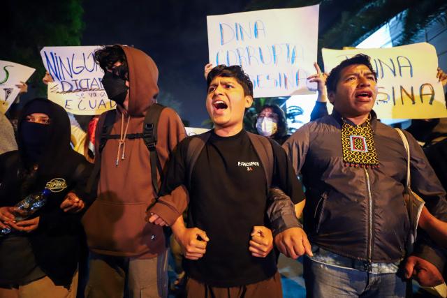 Demonstrators take part in a protest against President Dina Boluarte in front of the Ecuador embassy after the congress approved four motions of impeachment against the Peruvian in Lima on October 9, 2025. Peru's main political forces presented four motions to Congress on Thursday calling for President Dina Boluarte to be impeached in light of the severe security crisis, according to documents filed in plenary session. (Photo by Jorge CERDAN / AFP)