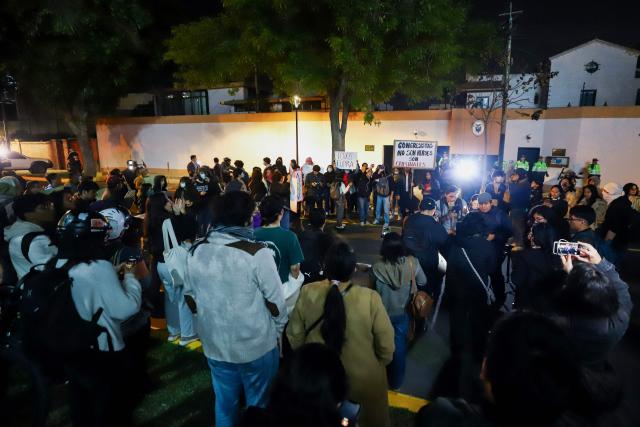 Demonstrators take part in a protest against President Dina Boluarte in front of the Ecuador embassy after the congress approved four motions of impeachment against the Peruvian in Lima on October 9, 2025. Peru's main political forces presented four motions to Congress on Thursday calling for President Dina Boluarte to be impeached in light of the severe security crisis, according to documents filed in plenary session. (Photo by Jorge CERDAN / AFP)