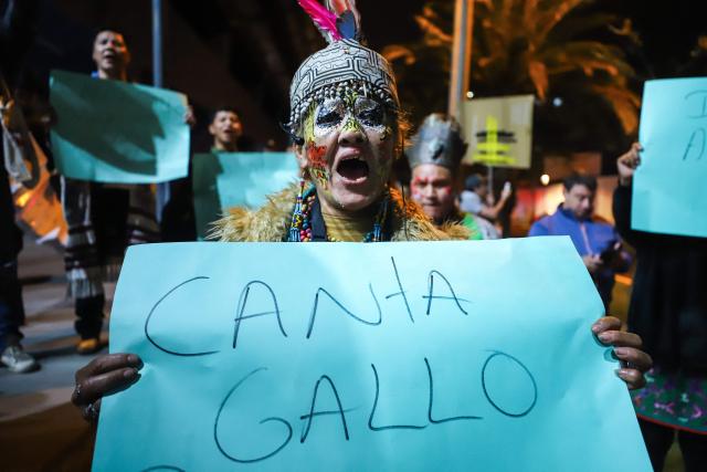 A demonstrator shouts slogans as she takes part in a protest against President Dina Boluarte in front of the Ecuador embassy after the congress approved four motions of impeachment against the Peruvian in Lima on October 9, 2025. Peru's main political forces presented four motions to Congress on Thursday calling for President Dina Boluarte to be impeached in light of the severe security crisis, according to documents filed in plenary session. (Photo by Jorge CERDAN / AFP)