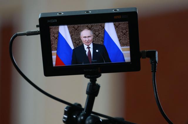 In this pool photograph distributed by the Russian state agency Sputnik, Russia's President Vladimir Putin meets with the Russian media after a meeting of the Commonwealth of Independent States (CIS) Heads of State Council in Dushanbe on October 10, 2025. (Photo by Vladimir SMIRNOV / POOL / AFP)