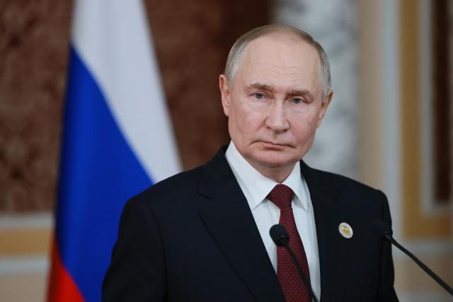 In this pool photograph distributed by the Russian state agency Sputnik, Russia's President Vladimir Putin meets with the Russian media after a meeting of the Commonwealth of Independent States (CIS) Heads of State Council in Dushanbe on October 10, 2025. (Photo by Vladimir SMIRNOV / POOL / AFP)