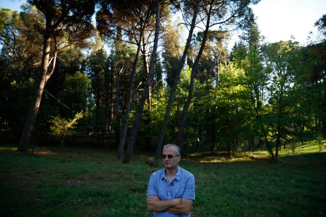 Forest engineer Abdulla Diku speaks to AFP journalist in Tirana, on September 16, 2025. Weeks of violent wildfires have devastated pine forests around Skenderbegas in central Albania’s Gramsh region, destroying more than 700 hectares of woodland and dozens of homes with livestock and wildlife among the victims, as the country faced extreme heat and drought on summer 2025, making it one of the Balkan nations most affected by wildfires. (Photo by Adnan Beci / AFP)