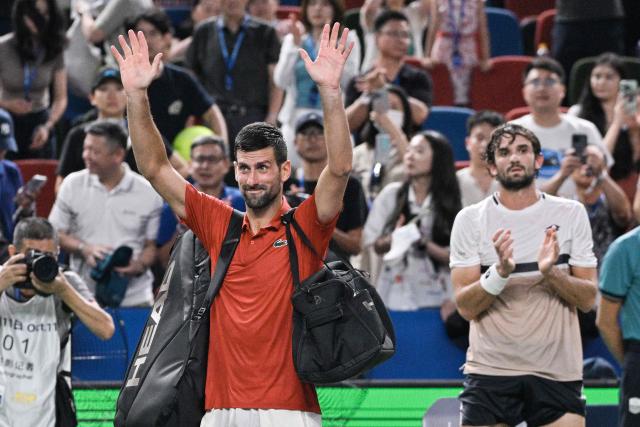 Serbia’s Novak Djokovic acknowledges spectators after losing in his men’s singles semi-final match against Monaco’s Valentin Vacherot at the Shanghai Masters tennis tournament in Shanghai on October 11, 2025. (Photo by Hector RETAMAL / AFP)