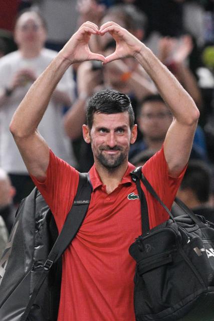 Serbia’s Novak Djokovic acknowledges spectators after losing in his men’s singles semi-final match against Monaco’s Valentin Vacherot at the Shanghai Masters tennis tournament in Shanghai on October 11, 2025. (Photo by Hector RETAMAL / AFP)