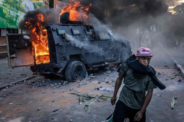 Protesters vandalise a Gendarmerie armoured vehicle as members of a section of the Malagasy army take control of the area around Lake Anosy following clashes between demonstrators and security forces during protests calling for the resignation of President Andry Rajoelina in Antananarivo, on October 11, 2025. Groups of Madagascar soldiers joined thousands of protestors in the capital on October 11, 2025, after announcing they would refuse any orders to shoot demonstrators.
Fresh youth-led demonstrations in Antananarivo drew large crowds in one of the biggest gatherings since a protest movement erupted on the Indian Ocean island on September 25.
After police used stun grenades and tear gas to try to disperse the demonstrators, soldiers arrived at the heart of the gathering near the Lake Anosy area where they were welcomed with cheers. (Photo by Luis TATO / AFP)
