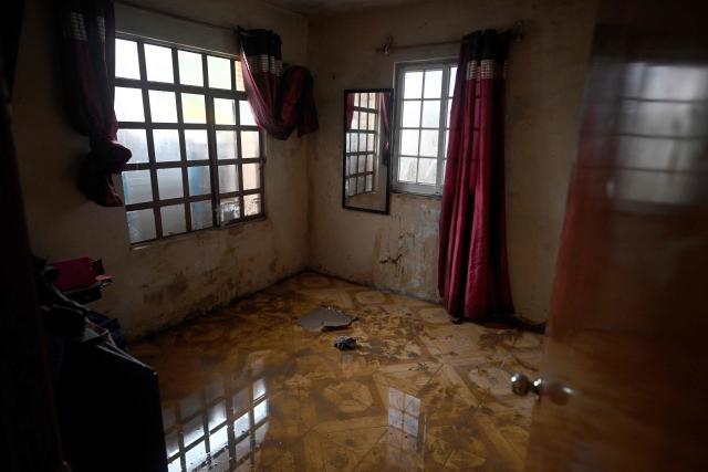 A flooded house due to the rains is pictured in the municipality of Huauchinango, Puebla State, Mexico on October 11, 2025. The death toll from heavy rains in Mexico rose to 37 on Saturday after nine more fatalities were confirmed, the Mexican government reported. (Photo by Alfredo ESTRELLA / AFP)