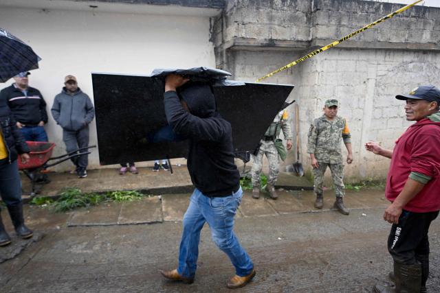 A man removes debris after the rains in the municipality of Huauchinango, Puebla State, Mexico on October 11, 2025. The death toll from heavy rains in Mexico rose to 37 on Saturday after nine more fatalities were confirmed, the Mexican government reported. (Photo by Alfredo ESTRELLA / AFP)