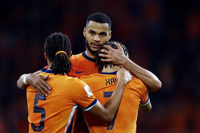 Netherlands' forward #11 Cody Gakpo (C) celebrates with Netherlands' defender #05 Nathan Ake (L) and Netherlands' midfielder #07 Xavi Simons after scoring his team's fourth goal during the FIFA World Cup 2026 Group G qualification football match between Netherlands and Finland, at the Johan Cruyff Arena in Amsterdam, on October 12, 2025. (Photo by MAURICE VAN STEEN / ANP / AFP) / Netherlands OUT