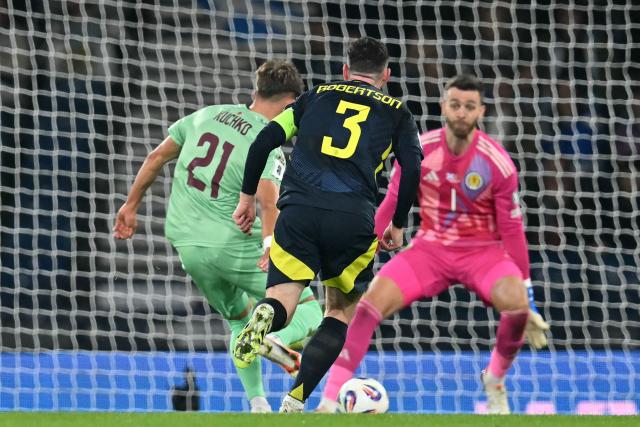 Belarus' forward #21 Gleb Kuchko (L) scores their late first goal during the 2026 World Cup Group C qualifier football match between Scotland and Belarus, at Hampden Park Stadium, in Glasgow, on October 12, 2025. (Photo by ANDY BUCHANAN / AFP)